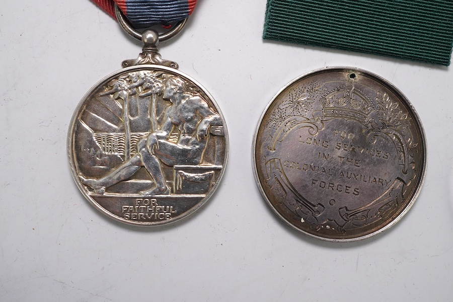 Four assorted Service medals; Vict unnamed Volunteer Long Service medal; GV Colonial Auxiliary Forces Long Service medal (disc only) to E.S.Ware; ERII ISM to Thomas Edward Downes; ERII ISM to William Henry Sharratt. Cond